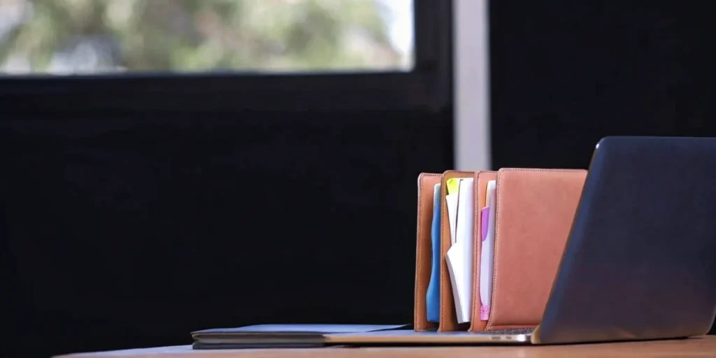 FDA 510(k) clearance preparation with laptop and organized files.