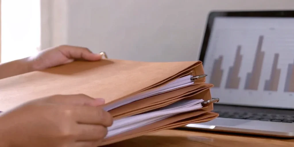 Regulatory strategy development: Documents, charts, and laptop.