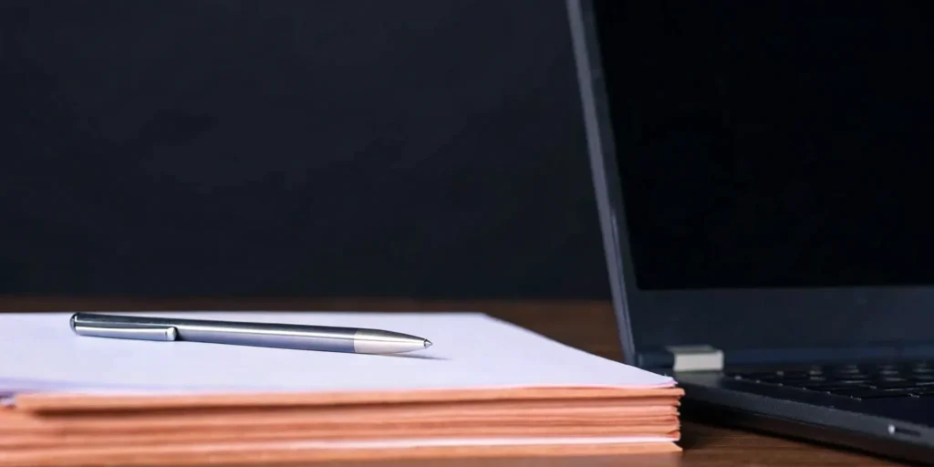 Tobacco product regulatory consulting documents and laptop.