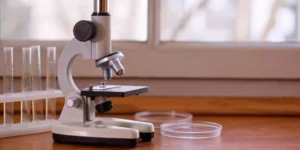 A microscope and lab tools used to maintain quality as part of a control plan.