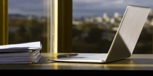 Preparing documents on a laptop for an FDA fast track designation submission.