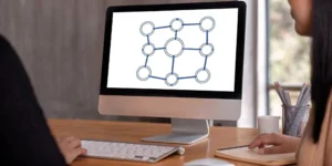 A team plans their FDA IND submission using a process flowchart on a computer.