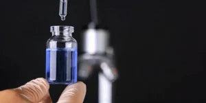 Vial with blue liquid and dropper for the orphan drug designation process.