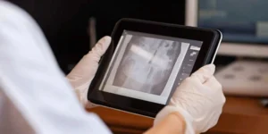 A medical professional reviews software as a medical device (SaMD) on a tablet.