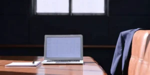 Conference table with a laptop and documents prepared for a formal FDA Type B meeting.