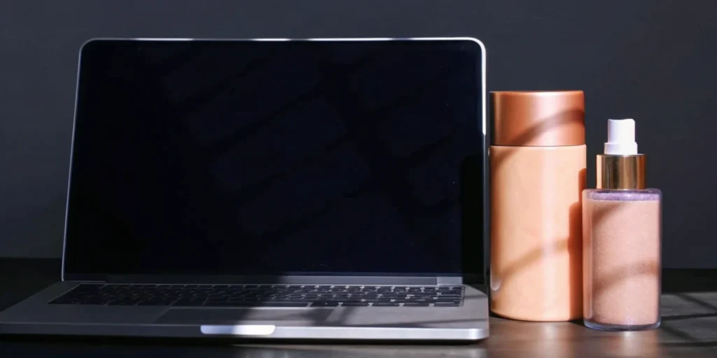 Cosmetics responsible person at a desk with a laptop, managing product safety and MoCRA compliance.