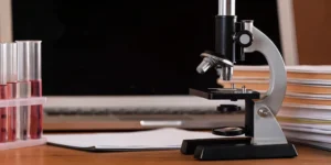 A microscope, test tubes, and documents for a nonconformance management investigation.