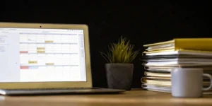 A desk with a laptop and folders organized for inspection readiness training.