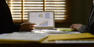 A team conducts a mock recall exercise by reviewing data and charts on a laptop.