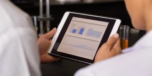 Team reviewing the key components of a validation master plan (VMP) on a tablet.