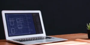 A blueprint for the 21 CFR 820 quality system regulation on a laptop screen.