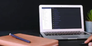 GCP training certificate course on a laptop screen next to a notebook and pen.