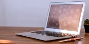 Laptop with a diagram outlining the ISO 9001 consulting process.