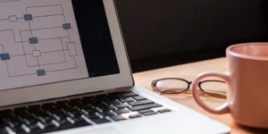 Planning regulatory compliance services with a flowchart on a laptop screen.