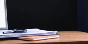 Magnifying glass analyzing documents for a GxP gap assessment.