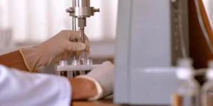 A technician performs a process performance qualification on pharmaceutical manufacturing equipment.