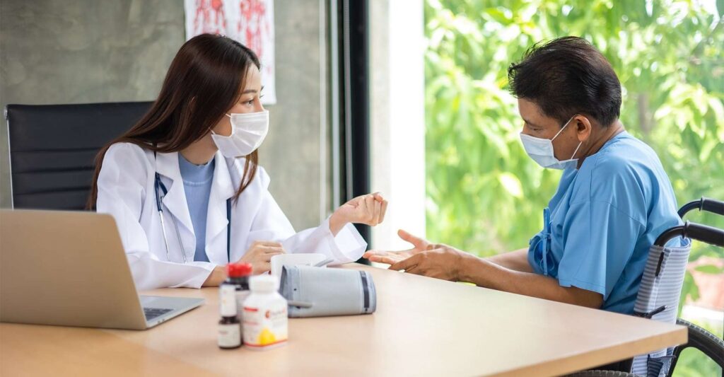 Masked doctor measuring patient's blood pressure