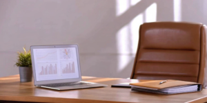 Desk with laptop charts analyzing regulatory compliance consulting services.