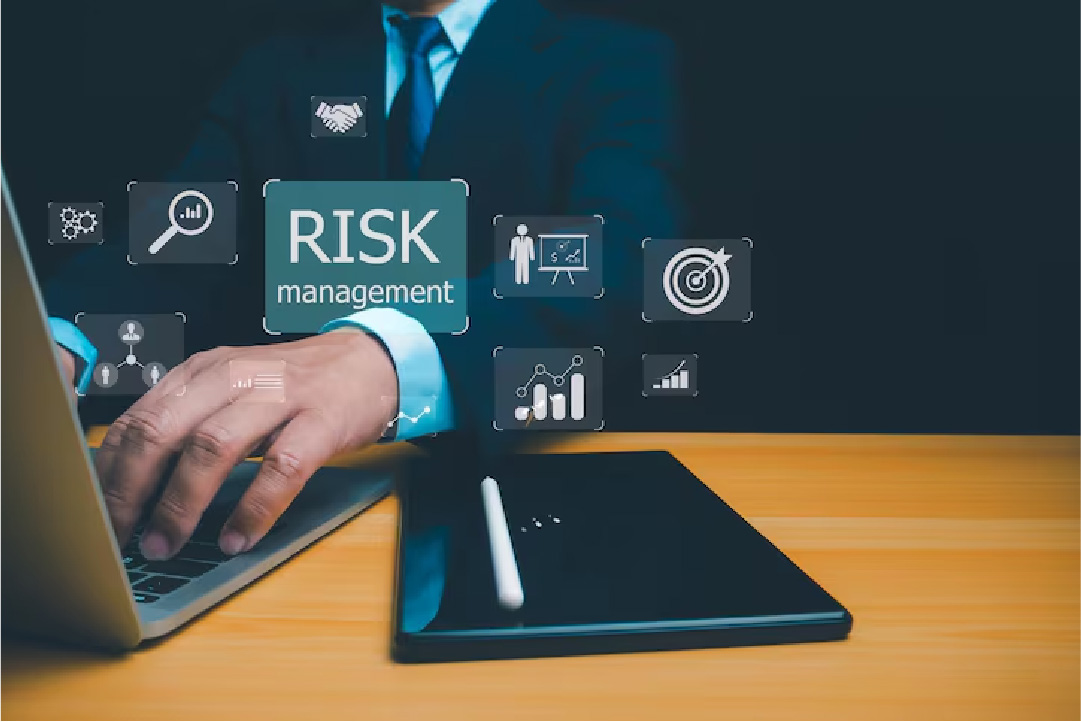 Professional using laptop with risk management icons