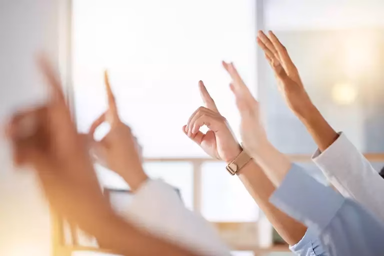 People raising their hands to ask questions