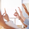 People raising their hands to ask questions